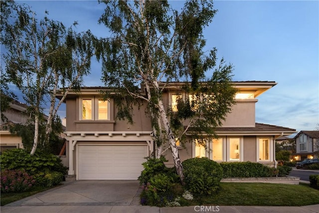 2567 Oakshore, Westlake Village, CA 91361 - view of front of house with concrete driveway, an attached garage, and stucco siding