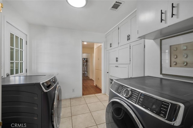31189 Alta Vista Dr, Redlands, CA 92373 - washroom featuring cabinet space, washer and clothes dryer, light tile patterned floors, and baseboards