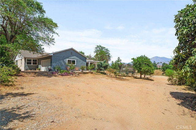 31189 Alta Vista Dr, Redlands, CA 92373 - view of yard with a garage, a trampoline, and a mountain view
