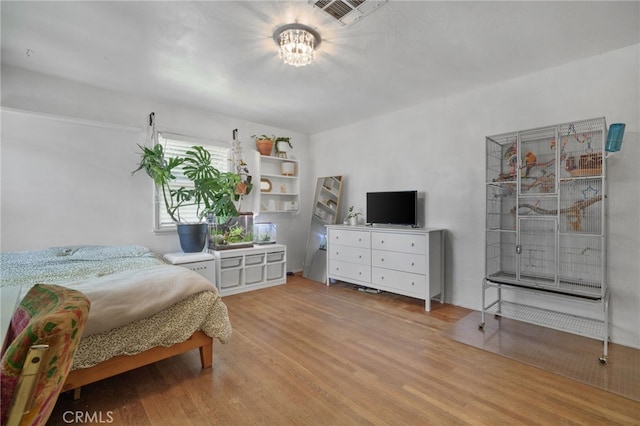 31189 Alta Vista Dr, Redlands, CA 92373 - bedroom featuring light wood-type flooring and a chandelier