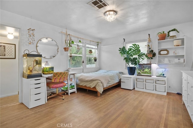 31189 Alta Vista Dr, Redlands, CA 92373 - bedroom featuring multiple windows, light wood-style flooring, and a chandelier