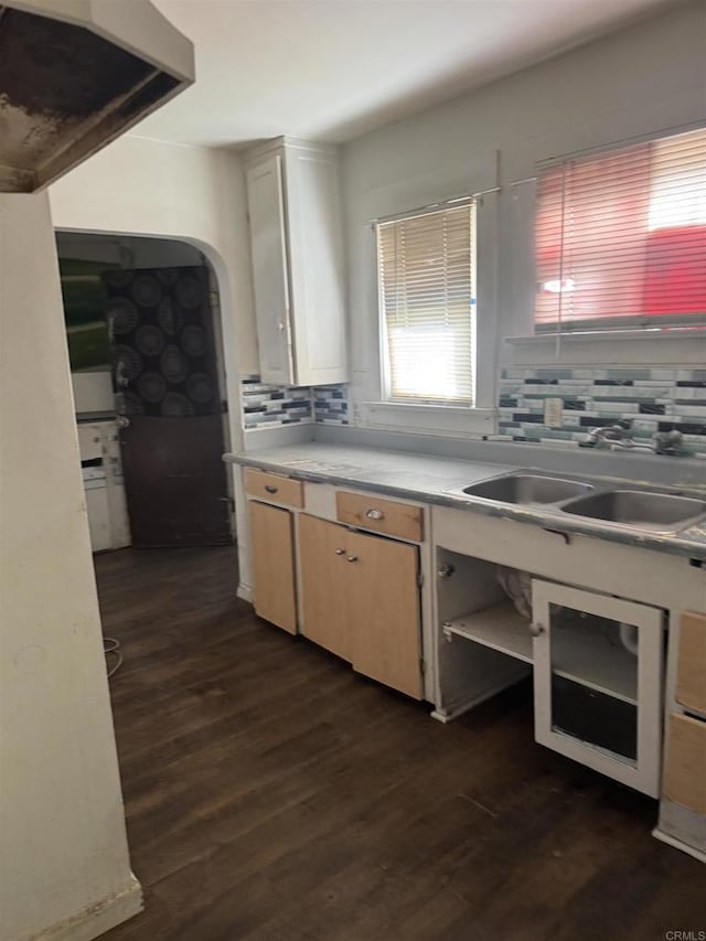 698 J St, Chula Vista, CA 91910 - kitchen with backsplash, a sink, light countertops, and dark wood-style flooring