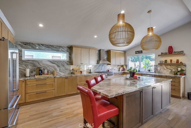 9171 Heatherton Cir, Huntington Beach, CA 92646 - kitchen featuring premium appliances, wall chimney exhaust hood, decorative backsplash, a center island, and light wood-style floors