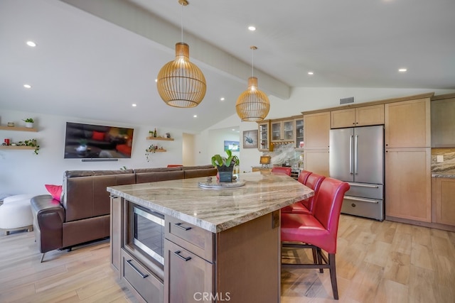 9171 Heatherton Cir, Huntington Beach, CA 92646 - kitchen featuring appliances with stainless steel finishes, light wood-type flooring, open floor plan, a kitchen island, and a breakfast bar area