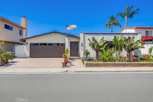 9171 Heatherton Cir, Huntington Beach, CA 92646 - ranch-style house featuring an attached garage, stucco siding, and decorative driveway