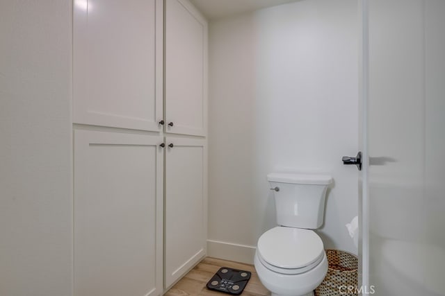 9171 Heatherton Cir, Huntington Beach, CA 92646 - bathroom featuring toilet, baseboards, and wood finished floors