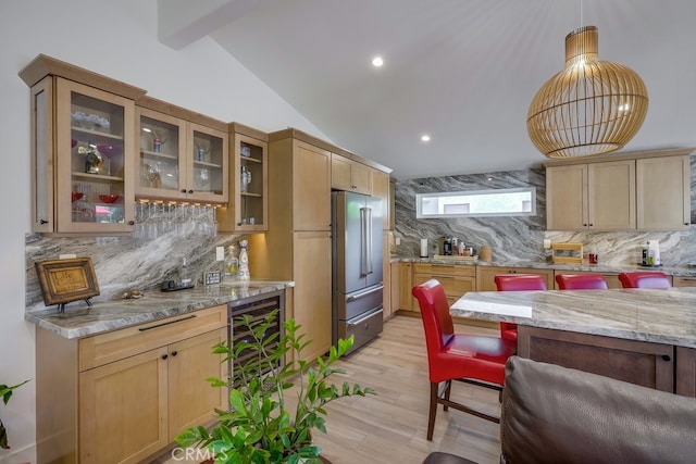 9171 Heatherton Cir, Huntington Beach, CA 92646 - kitchen with high end refrigerator, tasteful backsplash, light stone countertops, light wood-style floors, and vaulted ceiling