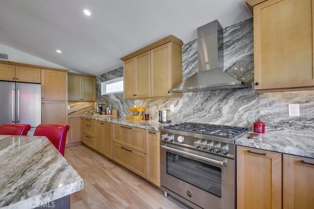 9171 Heatherton Cir, Huntington Beach, CA 92646 - kitchen with high quality appliances, wall chimney range hood, light brown cabinets, lofted ceiling, and light wood-style flooring