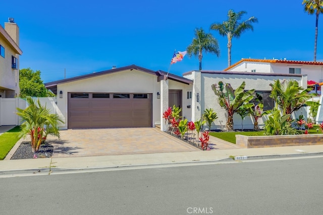 9171 Heatherton Cir, Huntington Beach, CA 92646 - view of front of home featuring stucco siding, an attached garage, and driveway