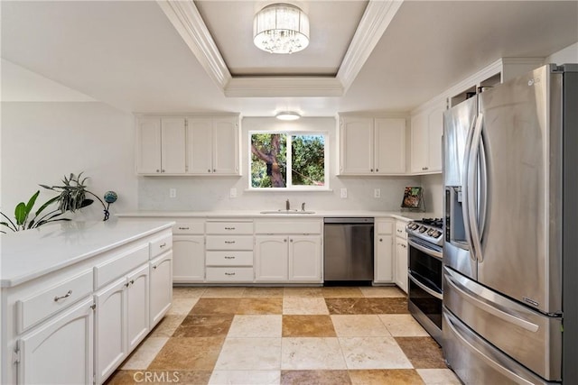 10755 Santa Ana Rd, Atascadero, CA 93422 - kitchen featuring appliances with stainless steel finishes, a raised ceiling, white cabinets, crown molding, and a chandelier