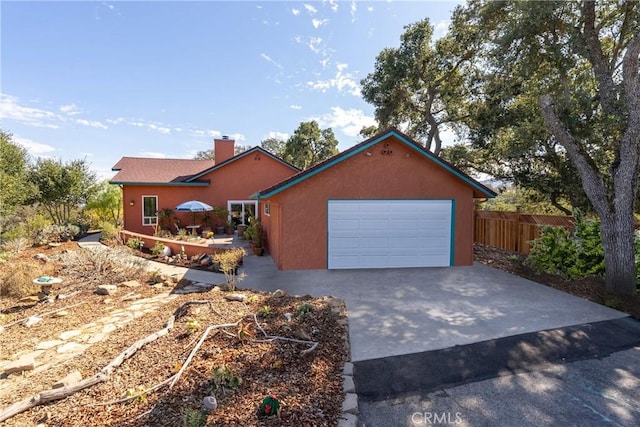 10755 Santa Ana Rd, Atascadero, CA 93422 - view of front facade with driveway, a chimney, stucco siding, and a garage