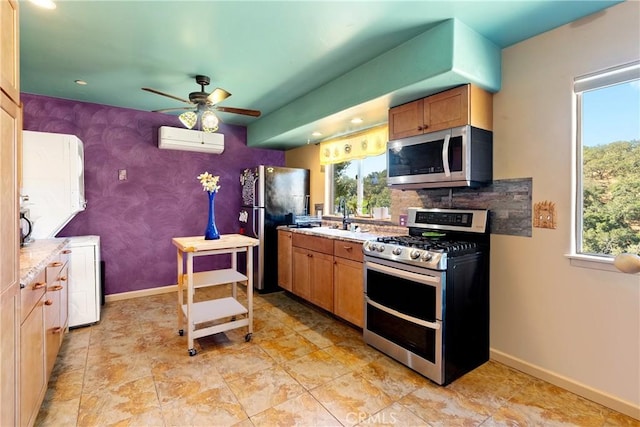 10755 Santa Ana Rd, Atascadero, CA 93422 - kitchen featuring appliances with stainless steel finishes, a wall mounted AC, a ceiling fan, plenty of natural light, and recessed lighting