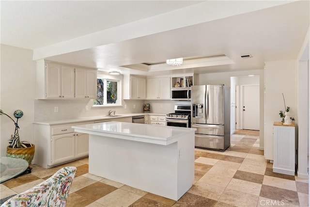 10755 Santa Ana Rd, Atascadero, CA 93422 - kitchen with appliances with stainless steel finishes, a raised ceiling, a sink, open shelves, and light countertops