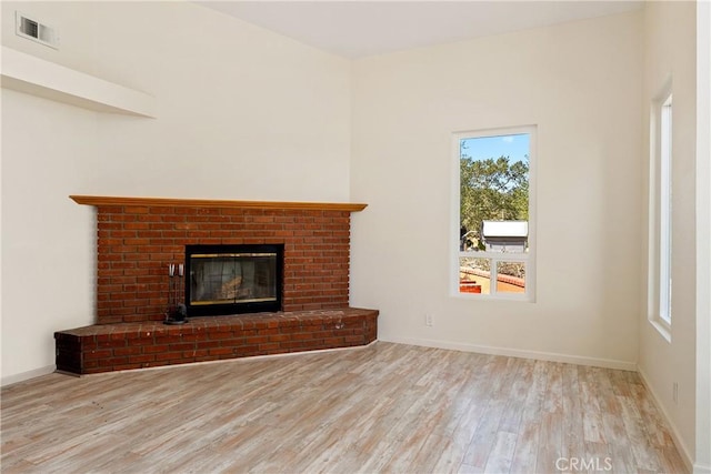 10755 Santa Ana Rd, Atascadero, CA 93422 - unfurnished living room with wood finished floors, plenty of natural light, a fireplace, and baseboards