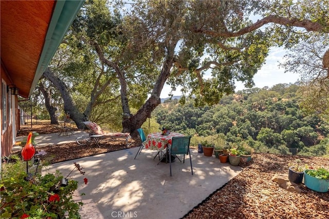10755 Santa Ana Rd, Atascadero, CA 93422 - view of patio with outdoor dining space and a wooded view