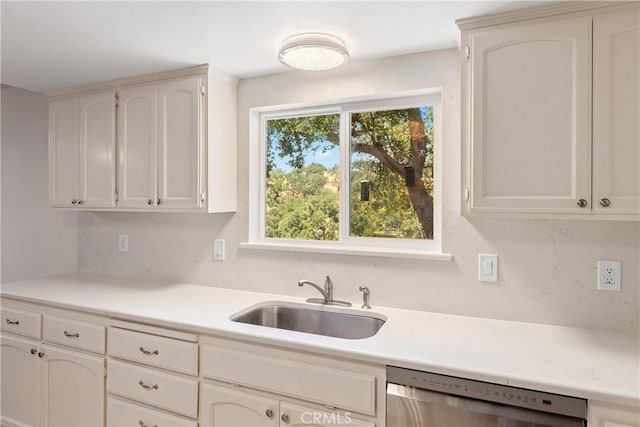 10755 Santa Ana Rd, Atascadero, CA 93422 - kitchen featuring stainless steel dishwasher, a sink, light countertops, and white cabinets