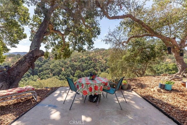 10755 Santa Ana Rd, Atascadero, CA 93422 - view of patio / terrace featuring outdoor dining space and a wooded view