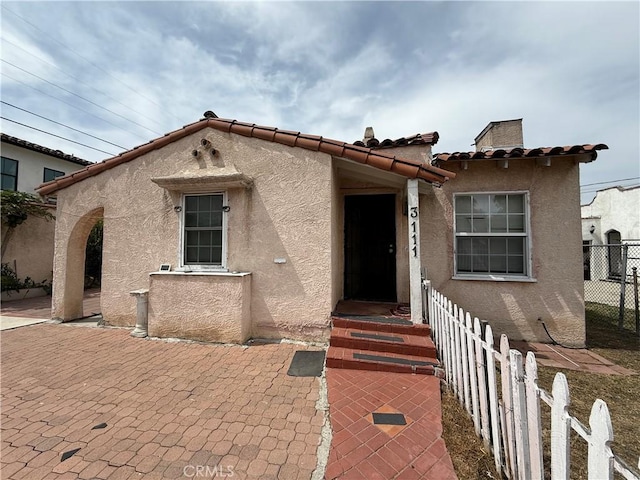 3111 W 57th St, Los Angeles, CA 90043 - view of front of house featuring stucco siding, a tile roof, and a patio area