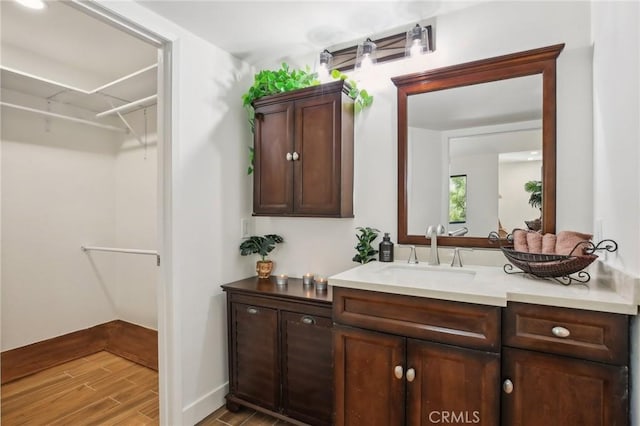 25761 Le Parc Unit 89, Lake Forest, CA 92630 - bathroom featuring vanity, a walk in closet, and wood finished floors