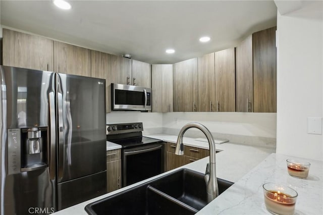 25761 Le Parc Unit 89, Lake Forest, CA 92630 - kitchen with appliances with stainless steel finishes, a sink, light stone counters, recessed lighting, and modern cabinets