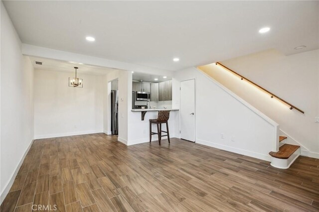 25761 Le Parc Unit 89, Lake Forest, CA 92630 - unfurnished living room featuring wood finished floors, a chandelier, stairs, and recessed lighting