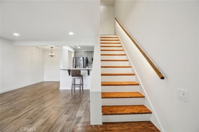 25761 Le Parc Unit 89, Lake Forest, CA 92630 - stairs featuring wood finished floors, a chandelier, recessed lighting, and baseboards