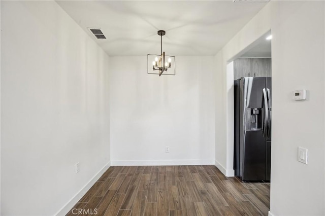 25761 Le Parc Unit 89, Lake Forest, CA 92630 - unfurnished dining area with dark wood-type flooring, a chandelier, and baseboards