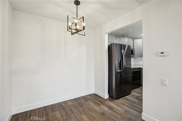 25761 Le Parc Unit 89, Lake Forest, CA 92630 - unfurnished dining area with dark wood finished floors, baseboards, and a chandelier