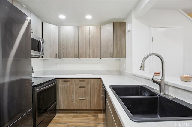 25761 Le Parc Unit 89, Lake Forest, CA 92630 - kitchen featuring stainless steel appliances, a sink, recessed lighting, light countertops, and wood finished floors