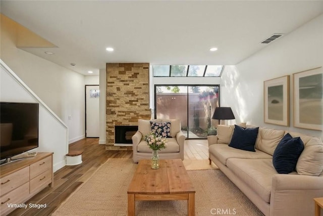 25761 Le Parc Unit 89, Lake Forest, CA 92630 - living area featuring wood finished floors, a fireplace, recessed lighting, and baseboards