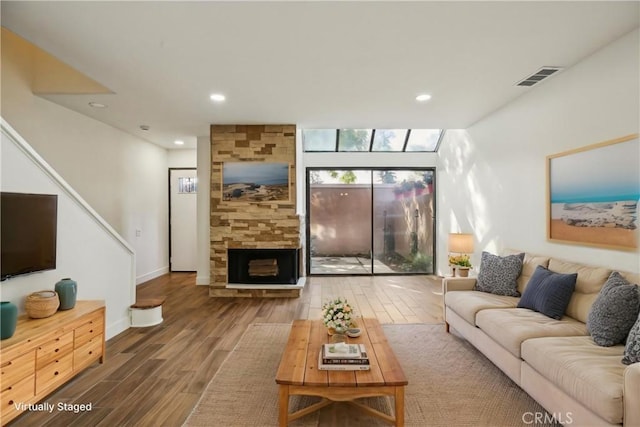 25761 Le Parc Unit 89, Lake Forest, CA 92630 - living area featuring wood finished floors, recessed lighting, a stone fireplace, and baseboards