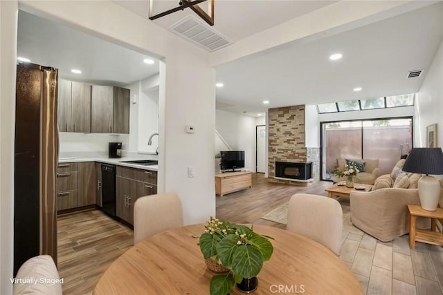 25761 Le Parc Unit 89, Lake Forest, CA 92630 - dining room featuring wood finished floors, a stone fireplace, and recessed lighting