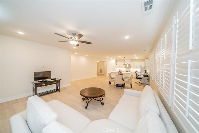 1521 Summerfield Way, Beaumont, CA 92223 - living area with light wood finished floors, ceiling fan, recessed lighting, and baseboards