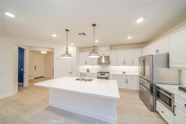 1521 Summerfield Way, Beaumont, CA 92223 - kitchen featuring under cabinet range hood, a sink, stainless steel appliances, white cabinets, and light wood finished floors