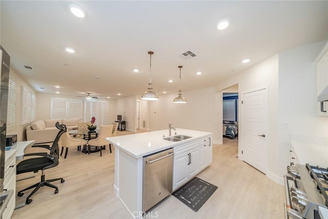 1521 Summerfield Way, Beaumont, CA 92223 - kitchen with appliances with stainless steel finishes, a sink, light wood-style flooring, open floor plan, and recessed lighting