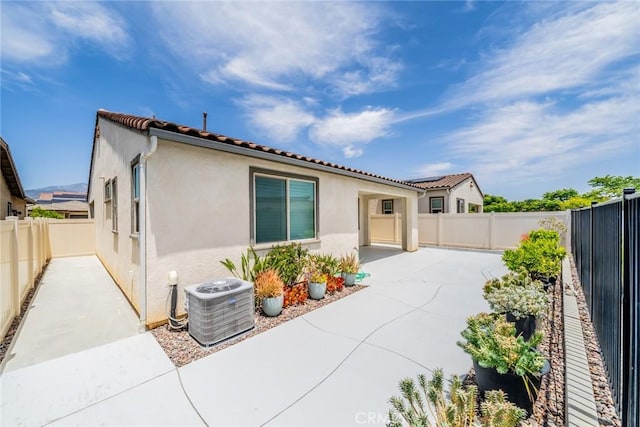 1521 Summerfield Way, Beaumont, CA 92223 - rear view of house featuring central AC unit, a patio area, stucco siding, a fenced backyard, and a tiled roof