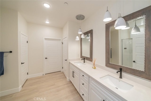 1521 Summerfield Way, Beaumont, CA 92223 - bathroom featuring double vanity, wood finished floors, baseboards, a shower with shower door, and recessed lighting