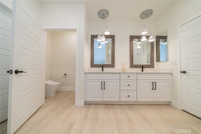 1521 Summerfield Way, Beaumont, CA 92223 - bathroom featuring toilet, double vanity, wood finished floors, and baseboards