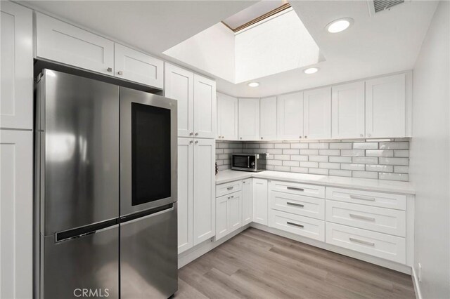 1995 Molino Ave Unit 301, Signal Hill, CA 90755 - kitchen with stainless steel appliances, light countertops, white cabinets, backsplash, and recessed lighting