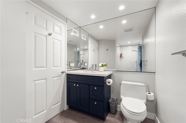 1995 Molino Ave Unit 301, Signal Hill, CA 90755 - bathroom with vanity, a shower, wood finished floors, toilet, and recessed lighting