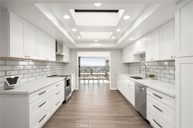 1995 Molino Ave Unit 301, Signal Hill, CA 90755 - kitchen with a sink, appliances with stainless steel finishes, a tray ceiling, white cabinetry, and recessed lighting