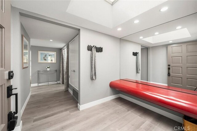 1995 Molino Ave Unit 301, Signal Hill, CA 90755 - hallway featuring baseboards, light wood-style flooring, recessed lighting, and a skylight