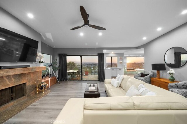 1995 Molino Ave Unit 301, Signal Hill, CA 90755 - living area featuring a high end fireplace, a ceiling fan, wood finished floors, and recessed lighting