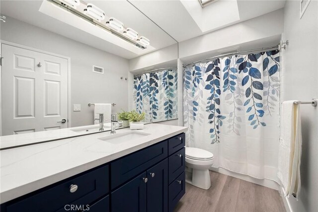 1995 Molino Ave Unit 301, Signal Hill, CA 90755 - bathroom featuring vanity, toilet, wood finished floors, and curtained shower