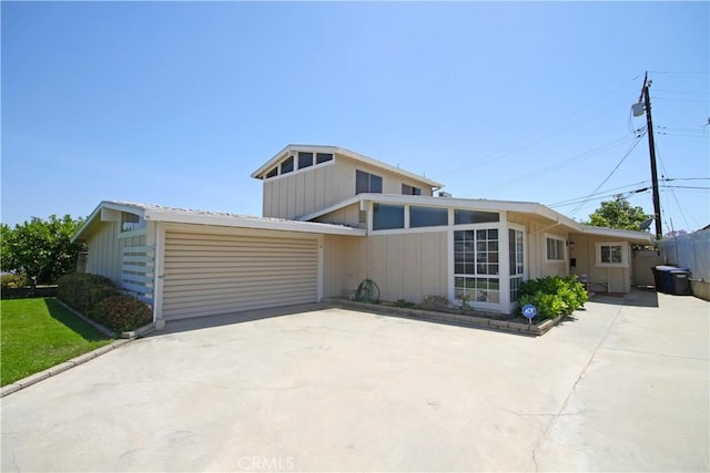 15234 Caravaca Rd, La Mirada, CA 90638 - mid-century inspired home featuring concrete driveway, an attached garage, and board and batten siding