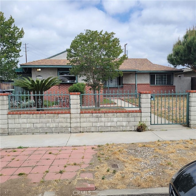 14173 Claretta St, Arleta, CA 91331 - view of front of house featuring a fenced front yard, brick siding, roof with shingles, and stucco siding