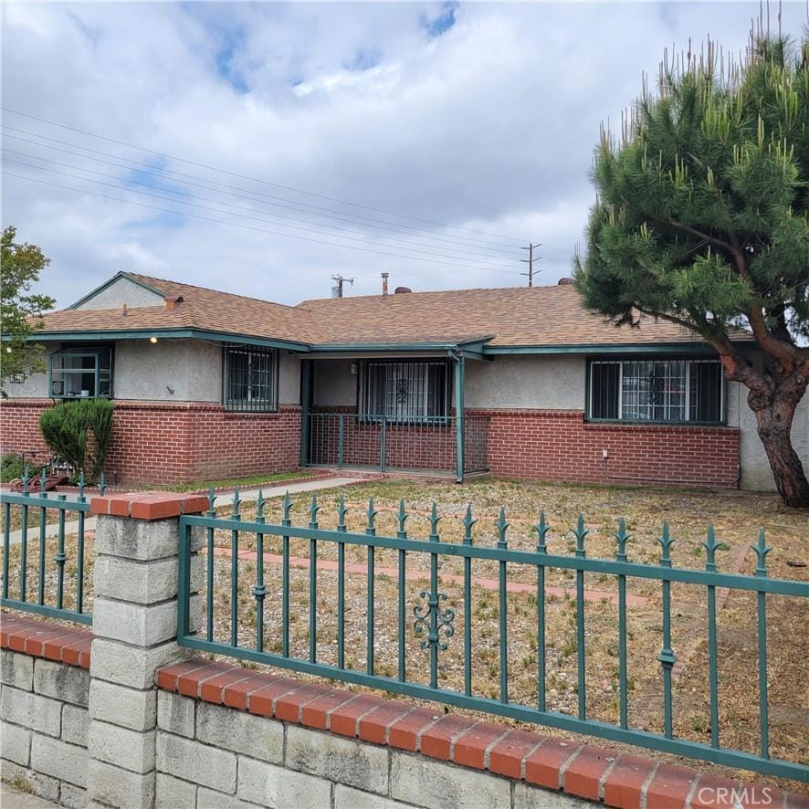14173 Claretta St, Arleta, CA 91331 - ranch-style house with a fenced front yard, brick siding, and stucco siding