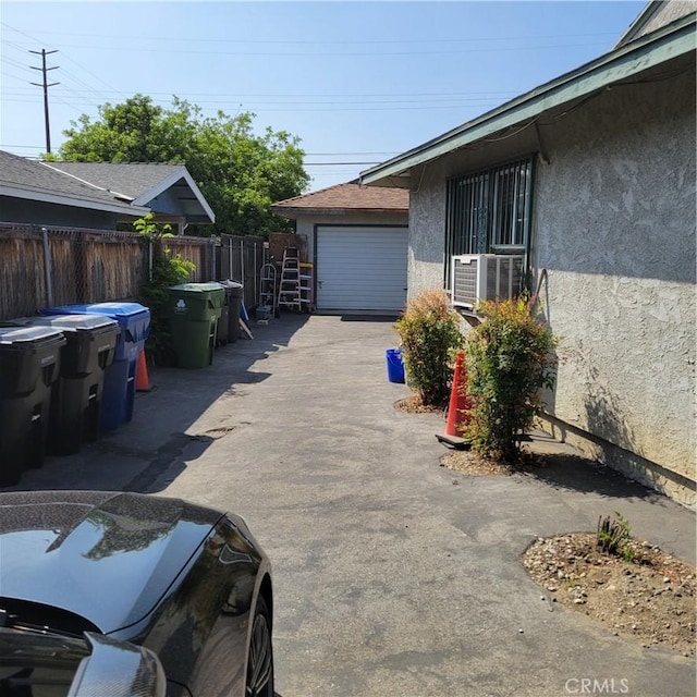 14173 Claretta St, Arleta, CA 91331 - garage with cooling unit and asphalt driveway