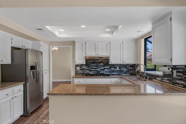 575 Nicole Dr, Newbury Park, CA 91320 - kitchen featuring stainless steel fridge with ice dispenser, a raised ceiling, a sink, stone counters, and light wood-style floors