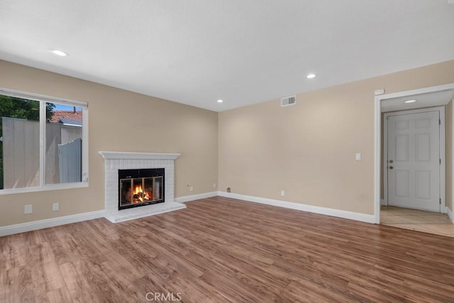 575 Nicole Dr, Newbury Park, CA 91320 - unfurnished living room featuring wood finished floors, a brick fireplace, baseboards, and recessed lighting